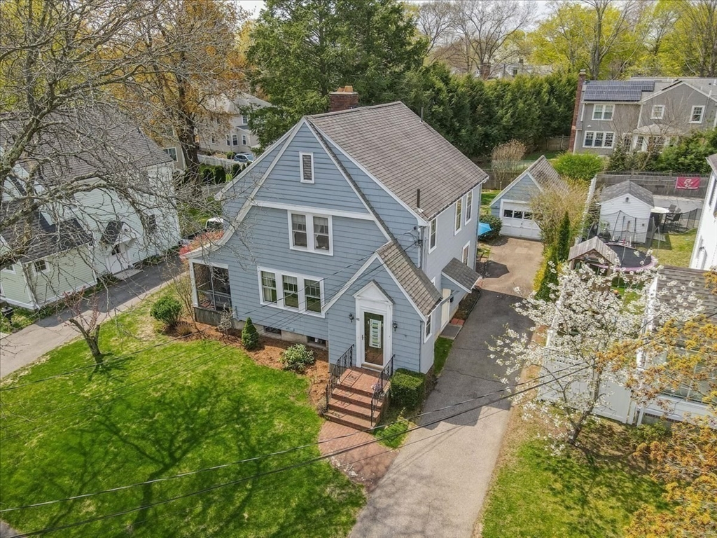62 Washington Avenue Needham, MA 02492 - Photo 39 of 42 a front view of a house with a garden