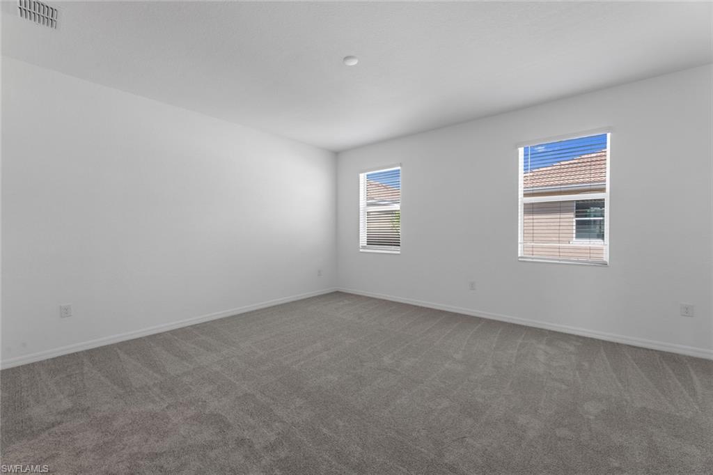 2856 Citrus Street Naples, FL 34120 - Photo 12 of 20 Empty room featuring carpet flooring and baseboards