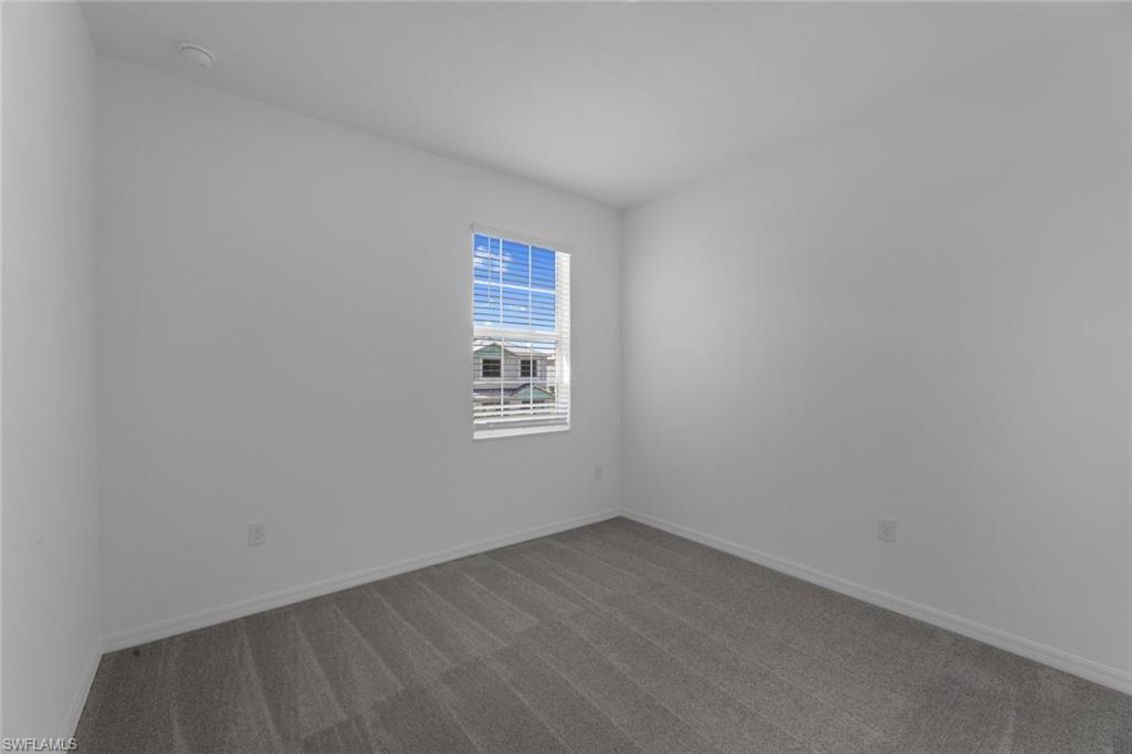 2856 Citrus Street Naples, FL 34120 - Photo 16 of 20 Carpeted spare room featuring baseboards
