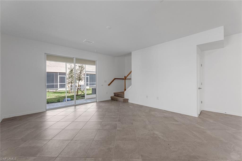 2856 Citrus Street Naples, FL 34120 - Photo 4 of 20 Unfurnished room featuring stairs and baseboards
