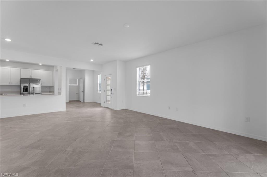 2856 Citrus Street Naples, FL 34120 - Photo 5 of 20 Unfurnished living room with baseboards and recessed lighting
