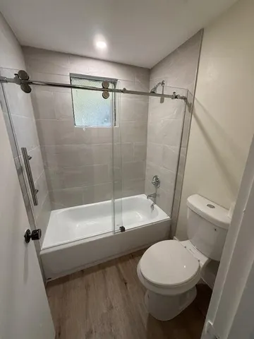 a bathroom with a toilet and a bath tub