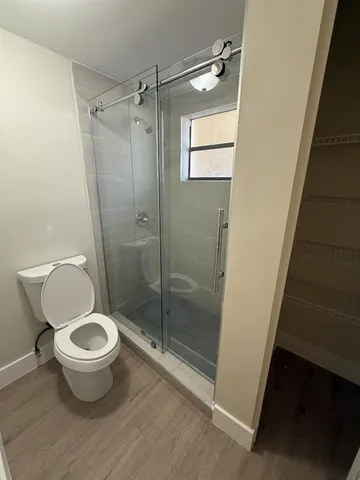 a bathroom with a toilet and a shower