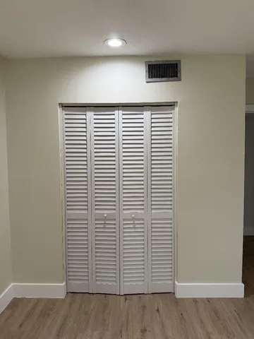 an empty room with wooden floor