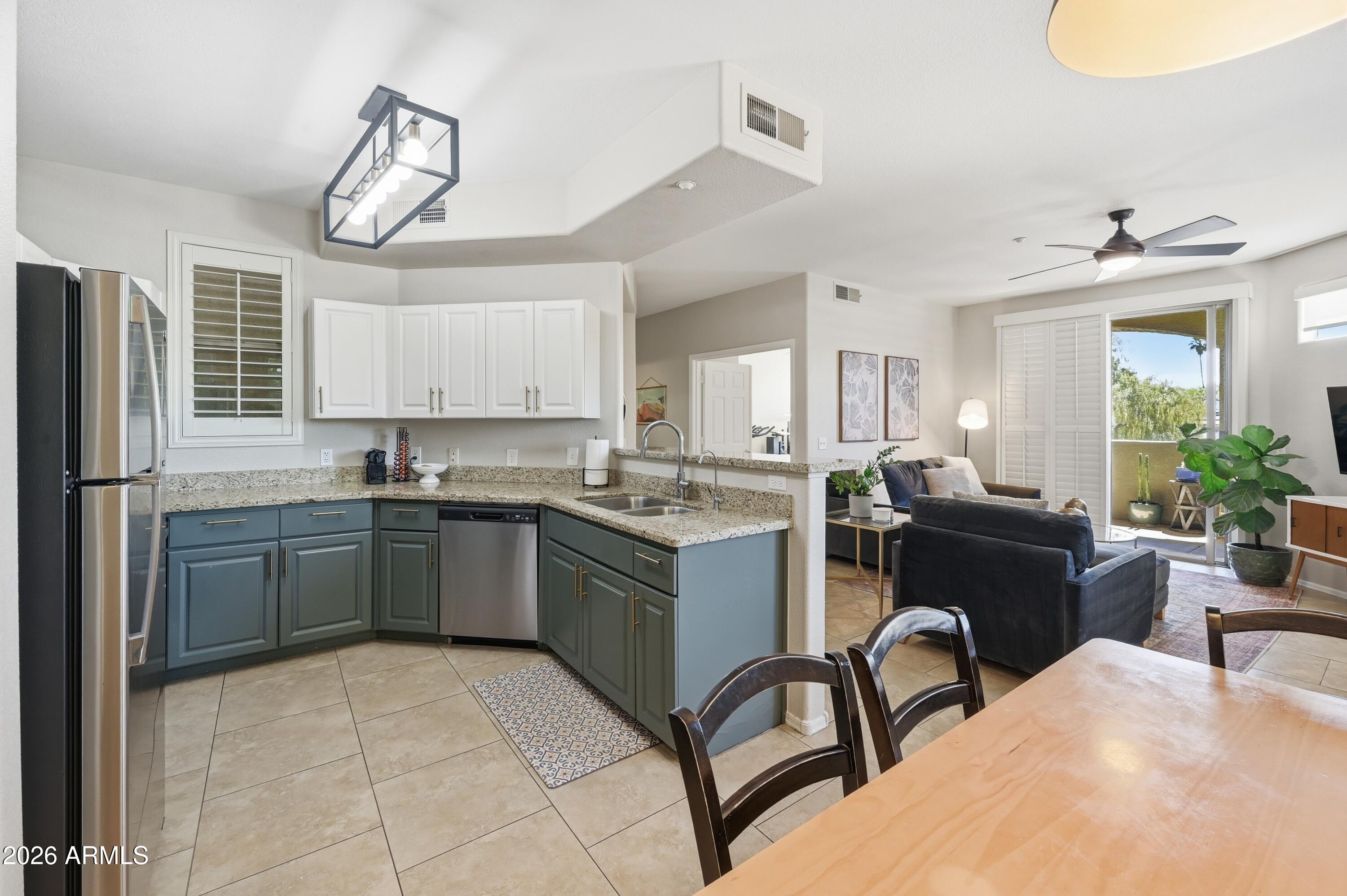 5303 North 7th Street, Unit 220 Phoenix, AZ 85014 - Photo 1 of 33 a kitchen with stainless steel appliances granite countertop a sink a stove and a refrigerator