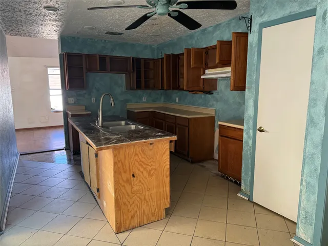 a kitchen with stainless steel appliances granite countertop a sink and a cabinets
