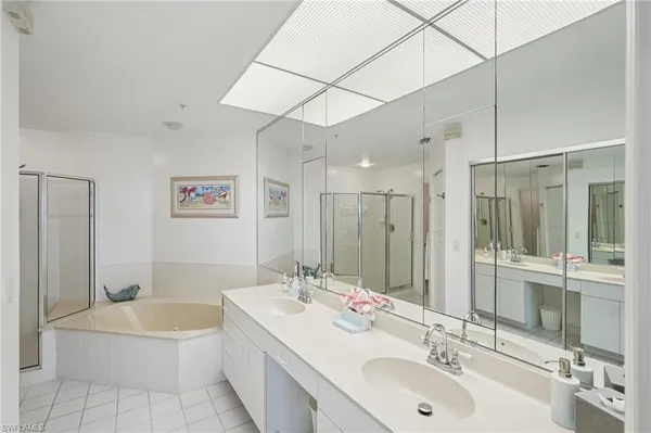 a bathroom with a double vanity sink mirror double and bathtub