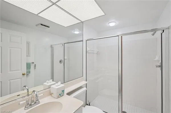 a bathroom with a shower sink and mirror