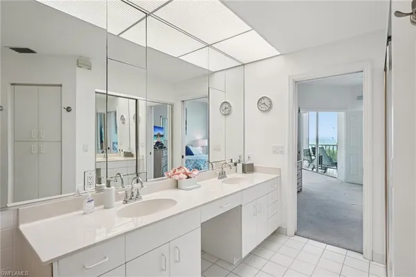 a bathroom with a double vanity sink mirror and double