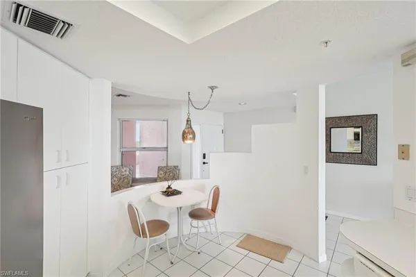 a kitchen with stainless steel appliances kitchen island granite countertop a refrigerator and a sink
