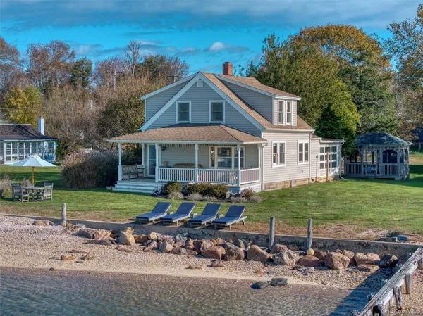 a backyard of a house with table and chairs