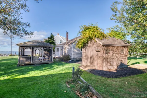 a view of a house with a yard and potted plants