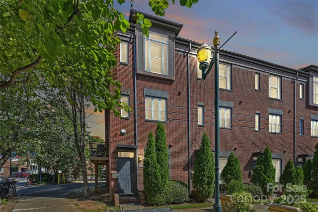 a view of a brick building next to a yard