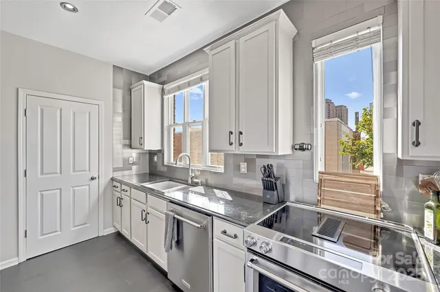 a kitchen that has a sink and a stove