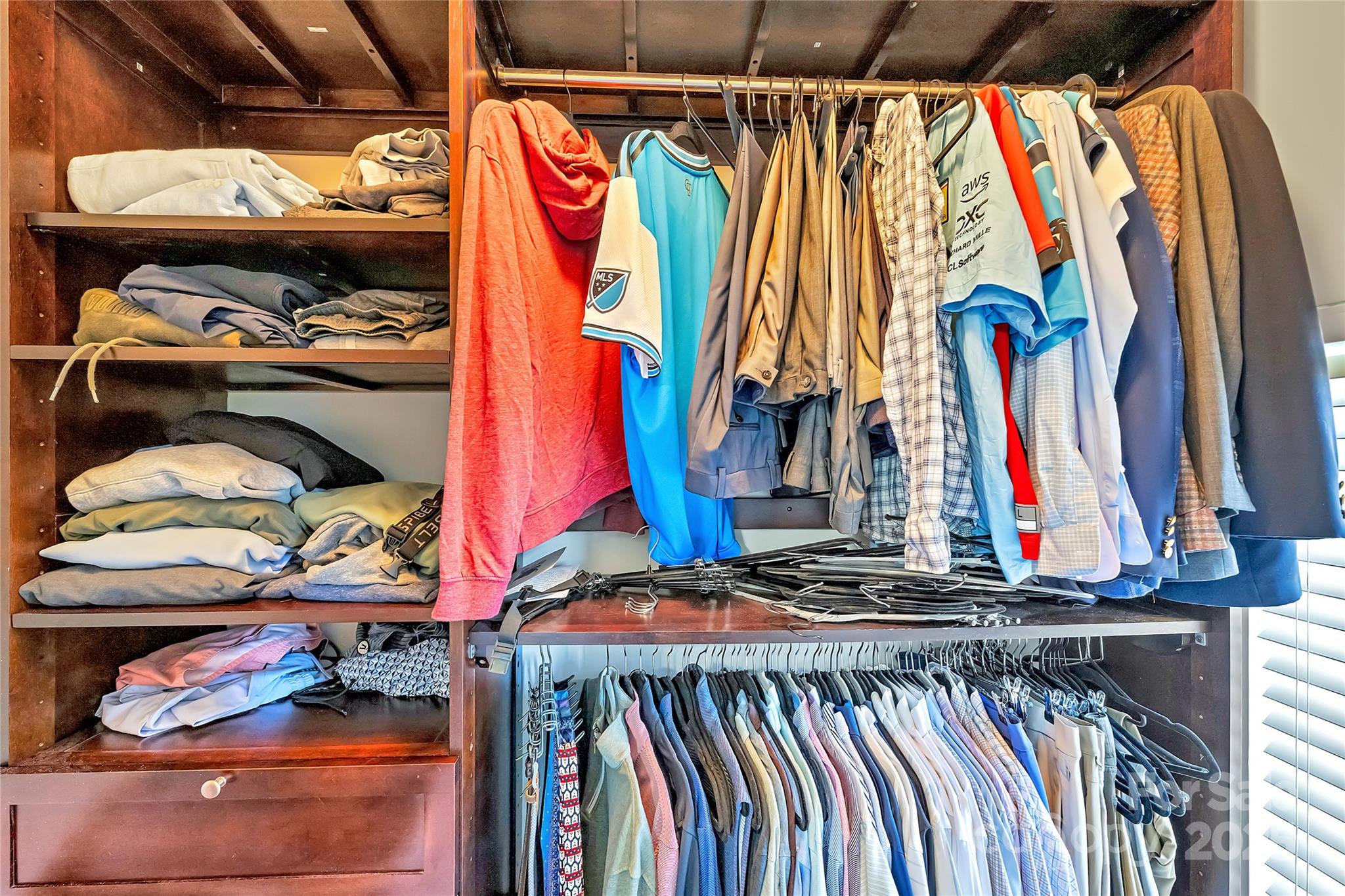 1425 Camden Road Charlotte, NC 28203 - Photo 22 of 37 a view of walk in closet with clothes and shoes