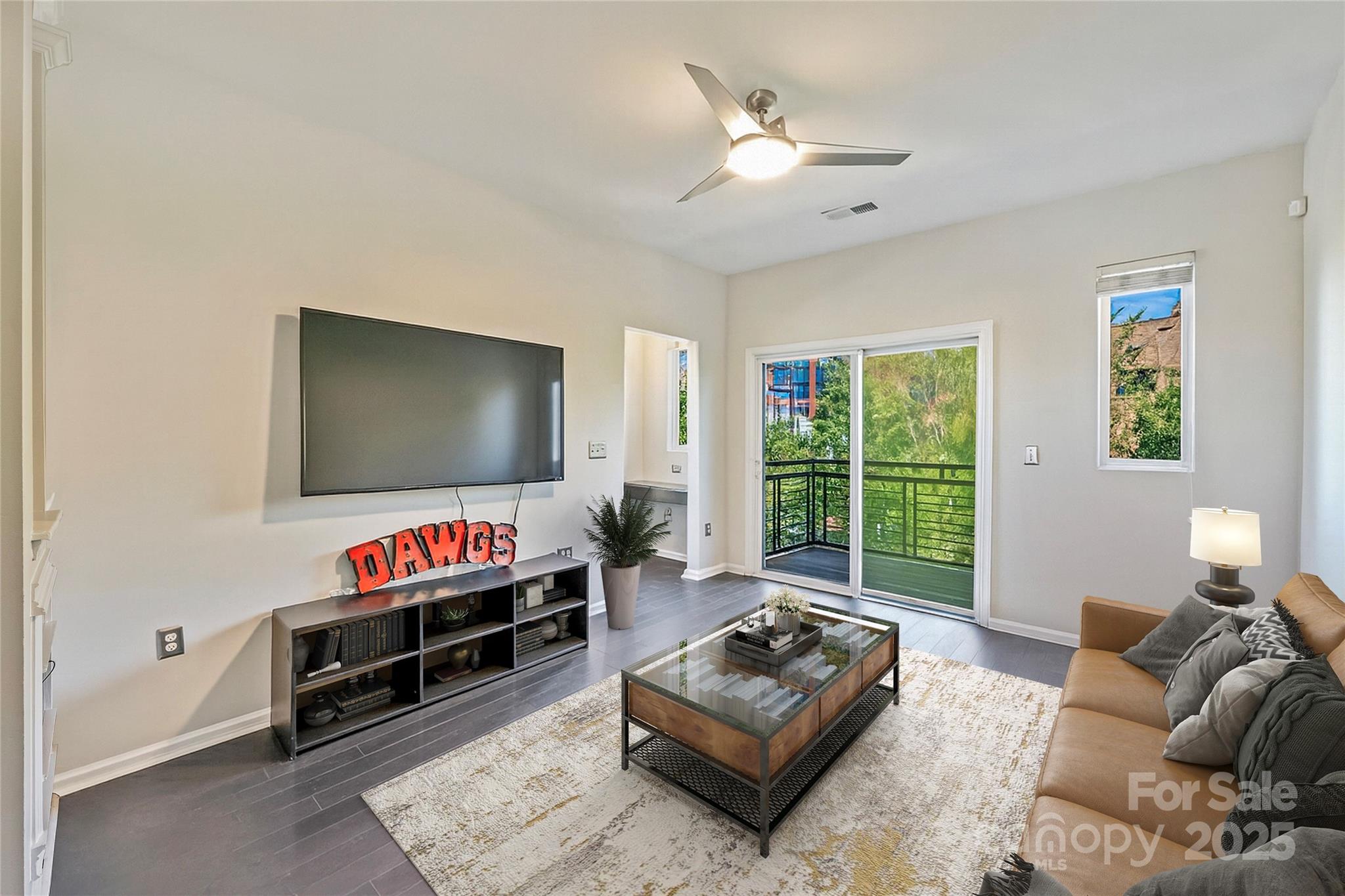 1425 Camden Road Charlotte, NC 28203 - Photo 7 of 37 a living room with furniture a flat screen tv and a large window