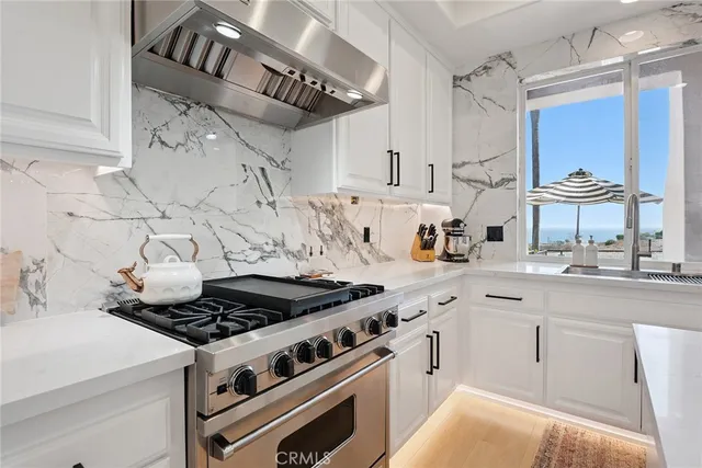 a kitchen with a stove and cabinets