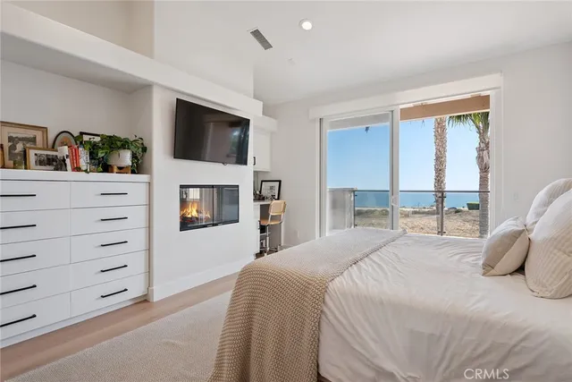 a bedroom with a bed and a television