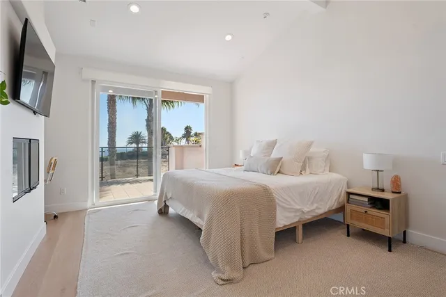 a spacious bedroom with a bed and a large window