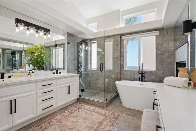 a spacious bathroom with sinks mirror and a bathtub