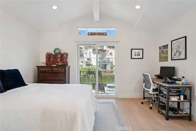 a bedroom with a bed and a desk