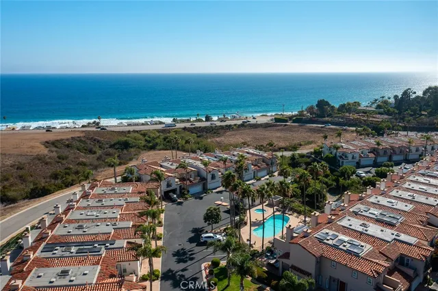 an aerial view of residential building and ocean