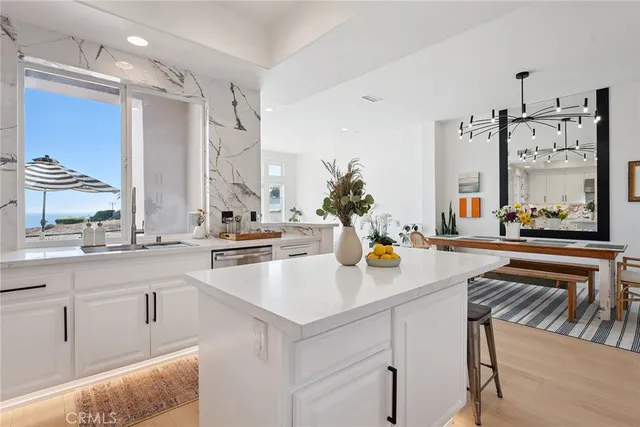 a kitchen with counter top space and living room