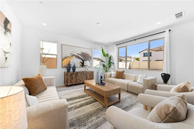 a living room with furniture and a large window