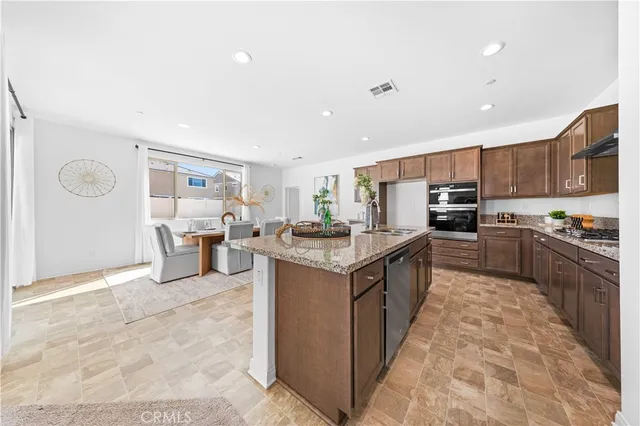 a large kitchen with stainless steel appliances lots of counter top space