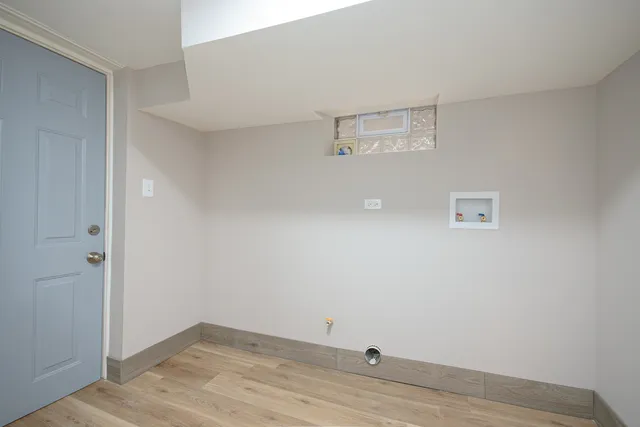an empty room with wooden floor and cabinet