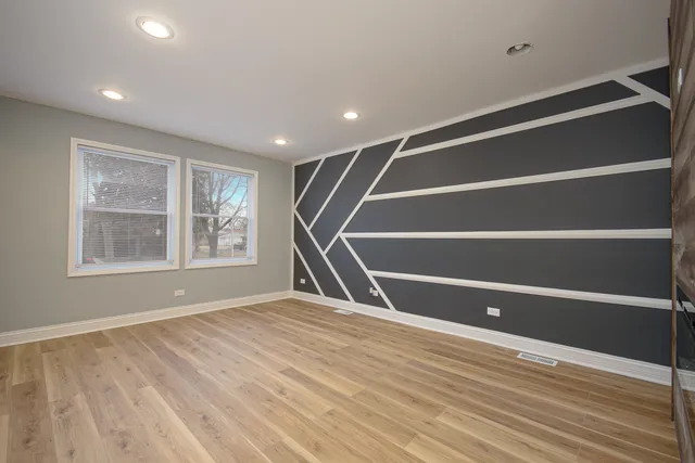 a view of room with window and wooden floor