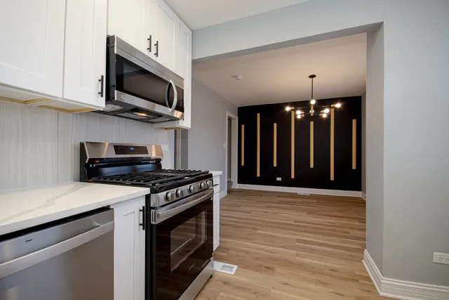 a kitchen with a stove and a microwave