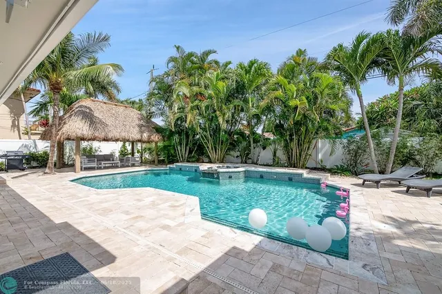 a view of a backyard with sitting area
