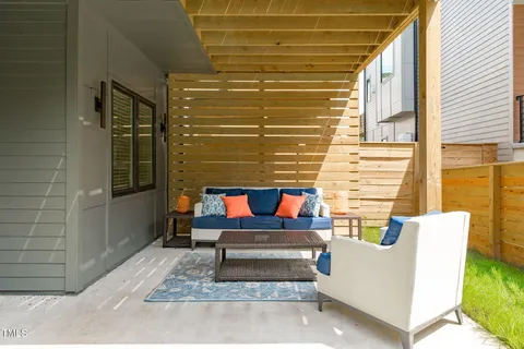 a backyard of a house with outdoor seating