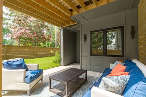 a backyard of a house with table and chairs