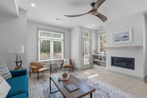 a living room with furniture a window and a fireplace