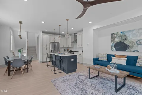 a living room with furniture and kitchen view