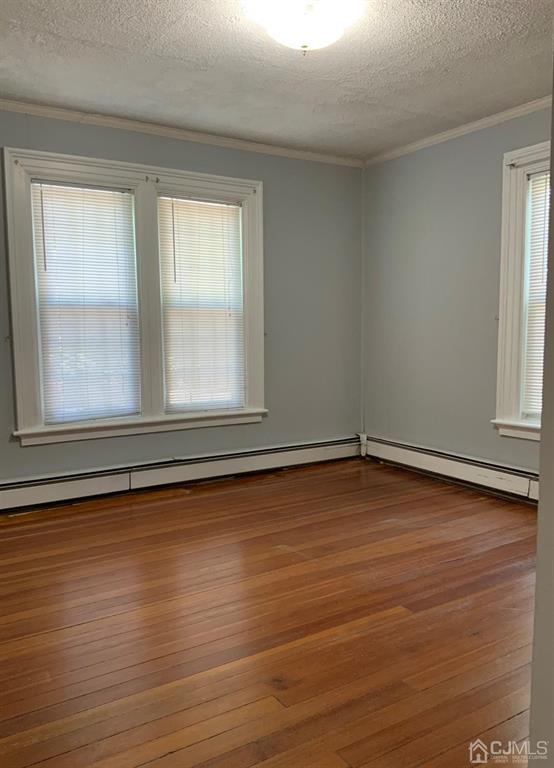 203 Woodbridge Avenue, Unit 2 Metuchen, NJ 08840 - Photo 6 of 13 a view of a room with wooden floor and window