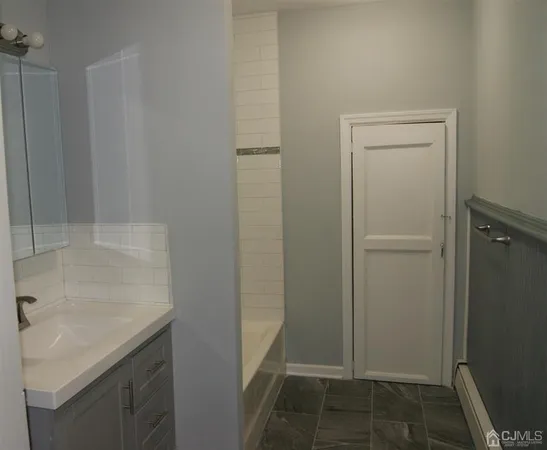 a bathroom with a sink and mirror