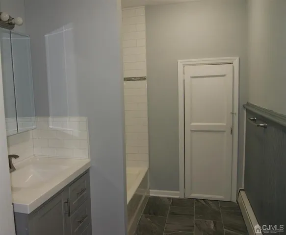 a bathroom with a sink and mirror
