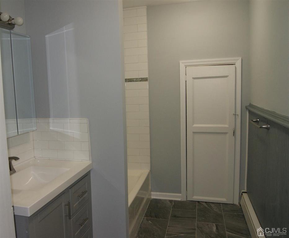 203 Woodbridge Avenue, Unit 2 Metuchen, NJ 08840 - Photo 7 of 13 a bathroom with a sink and mirror