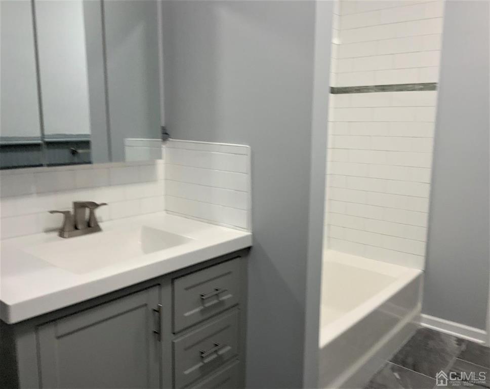 203 Woodbridge Avenue, Unit 2 Metuchen, NJ 08840 - Photo 8 of 13 a bathroom with a sink and a bathtub
