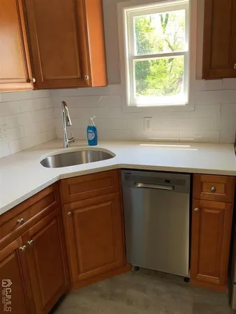 a kitchen with a sink cabinets and a window