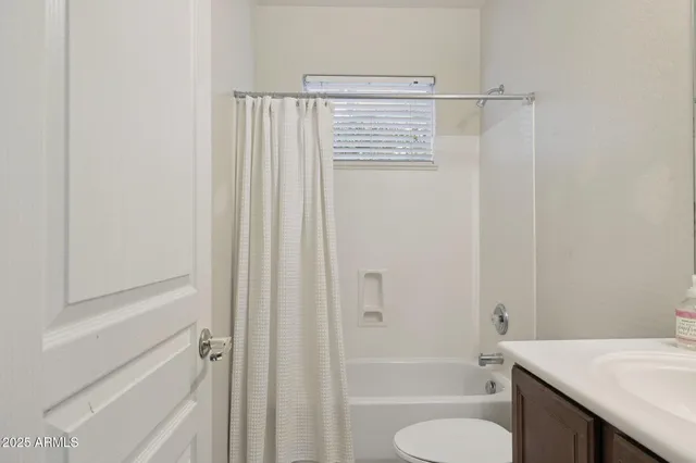 an empty room with chandelier fan