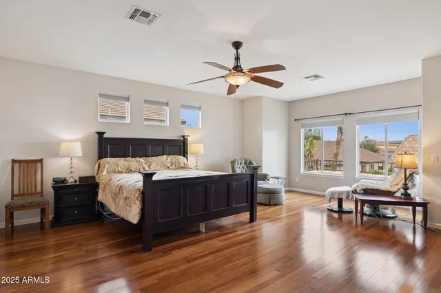 a view of a livingroom with furniture a ceiling fan and window