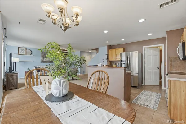 a view of a dining room with furniture a chandelier and wooden floor