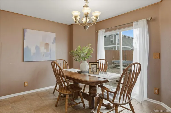 a dining room with furniture and chandelier