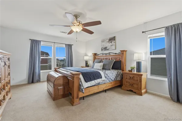 a bedroom with a bed and a chandelier