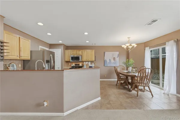 a living room with furniture a dining table and chairs
