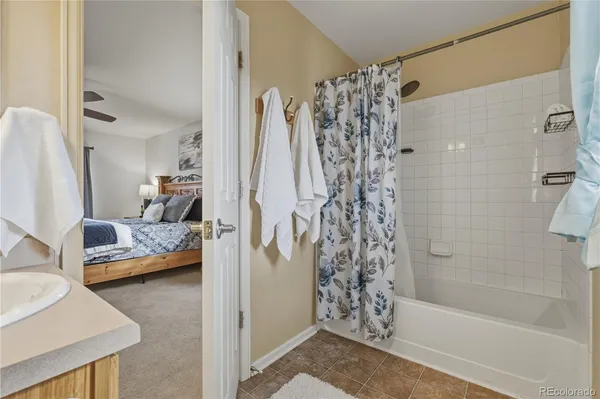 a bathroom with a tub shower and sink